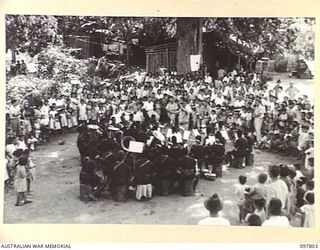 RATONGOR, NEW BRITAIN. 1945-10-10. THE ROYAL PAPUAN CONSTABULARY BAND PLAYING AT THE CHINESE INTERNMENT CAMP. THE BAND PLAYED FOR THE GALA DAY CELEBRATIONS HELD ON THE 34TH ANNIVERSARY OF THE ..