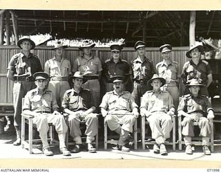 LAE, NEW GUINEA. 1944-04-01. MAJOR GENERAL B.M. MORRIS, DSO, GENERAL OFFICER COMMANDING AUSTRALIAN NEW GUINEA ADMINISTRATIVE UNIT, (CENTRE, FRONT ROW), WITH HEADQUARTERS STAFF, HEADQUARTERS LAE ..