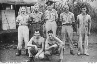 GOODENOUGH ISLAND, PAPUA. 1944. 30542 FLYING OFFICER HENRY ARTHUR HURST (MIDDLE BACK ROW) AND OTHER MEMBERS OF NO. 100 SQUADRON RAAF