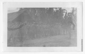 [Servicemen Standing in Rows Outside Tent]