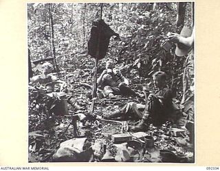GAZELLE PENINSULA, NEW BRITAIN, 1945-05-14. TROOPS OF A COMPANY, 37/52 INFANTRY BATTALION, TAKING A REST DURING THE FOURTH DAY OF THEIR TREK FROM RILE TO MAVELU, OPEN BAY