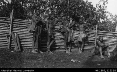 Several men by a fence near Government House