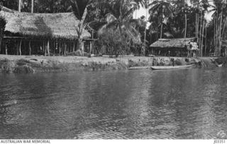 NEW GUINEA, C. 1915. A NATIVE VILLAGE OPPOSITE ANGORAM, ON THE BANKS OF THE SEPIK RIVER. (DONOR LT.-COM. G.A. HILL, RNR.)