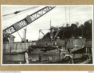 LAE, NEW GUINEA, 1943-11-05. ENGINEERS OF THE DETACHMENT OF HEADQUARTERS, 1052ND ENGINEERS PORT CONSTRUCTION AND REPAIR GROUP, UNITED STATES ARMY. WORKING ON THE CONSTRUCTION OF THE FIRST LIBERTY ..