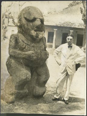 Peter Henry Buck in Tahiti, with a stone sculpture of a female deity from Ra'ivavae, Austral Islands