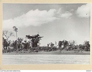 PIVA AIRSTRIP, TOROKINA, BOUGAINVILLE, 1945-07-12. SQUADRON LEADER W.A. HARDHAM, ROYAL NEW ZEALAND AIR FORCE, TAKING OFF IN A CORSAIR WITH LIEUTENANT KINNA'S MOVIE CAMERA FITTED IN THE BELLY TANK ..