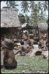 Mortuary ceremony: crowd of women gathered for exchange, fiber skirt valuable visible in center