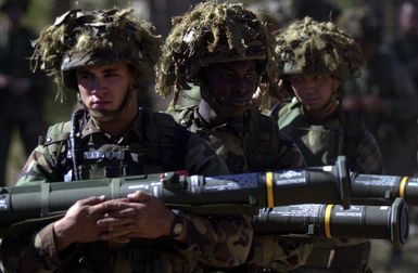 Marines from India Company, 3rd Battalion, 3rd Marines weapon platoon, Kaneohe Bay, Hawaii carry their Shoulder Mounted M136 AT4 Anti Armor Weapons to the range during Exercise TANDEM THRUST. India Company is conducting a live fire range exercise consisting of firing AT-4 Rocket Launchers, Shoulder Mounted Anti Armor Weapons, and M-2O3 Grenade Launchers at the Shoalwater Bay Training Area. TANDEM THRUST is a biennial combined United States and Australian military training exercise, held in the vicinity of Shoalwater Bay Training Area in Queensland, Australia. More than 27,000 Soldiers, Sailors, Airmen and Marines are participating, with Canadian units taking part as opposing forces. The...