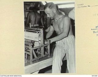 TOROKINA, BOUGAINVILLE. 1945-04-19. SERGEANT A.J. BYERS, A PATIENT AT THE 2/1 GENERAL HOSPITAL IN THE HOBBIES SECTION WORKING WITH WOOL AND LOOM PROVIDED BY THE RED CROSS SOCIETY