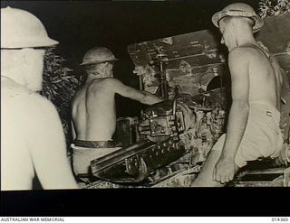 Pacific Area. c. 1942. An Australian gun crew ready for action at night
