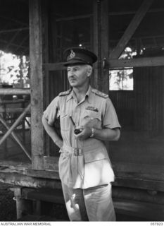 DOBODURA, NEW GUINEA. 1943-10-11. NX366 MAJOR GENERAL A. J. BOASE CBE, GENERAL OFFICER COMMANDING, 11TH AUSTRALIAN DIVISION, STANDING OUTSIDE HIS QUARTERS