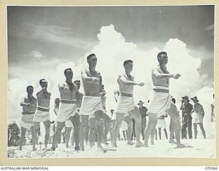 KELANOA, NEW GUINEA, 1944-02-20. THE 4TH INFANTRY BATTALION (NO. 1 TEAM), IN THE MARCHPAST AT THE MOST FORWARD BEACH CARNIVAL HELD IN NEW GUINEA. THE CARNIVAL WAS ORGANISED BY CAPTAIN A.E. RICHARDS ..