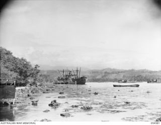 NEW GUINEA, 1943-07-21. FIRST SHOT OF A PANORAMA OF ORO BAY (JOINS 054582 AND 054583). LIBERTY SHIP AT WHARF. ORO BAY IS A MARVEL OF RAPID DEVELOPMENT OF ROADS AND SUPPLIES THE DOBODURA AIRFIELDS