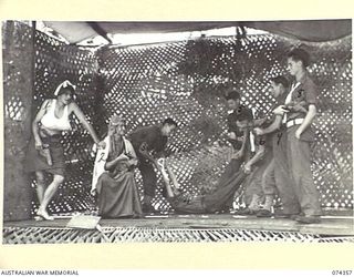 SIAR, NEW GUINEA. 1944-06-25.MEMBERS OF NO.6 PLATOON, HEADQUARTERS COMPANY, ACTING IN A GANGSTER PLAY DURING A CONCERT STAGED BY THE 57/60TH INFANTRY BATTALION CONCERT PARTY. IDENTIFIED PERSONNEL ..