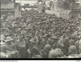 MOMOTE, LOS NEGROS ISLAND, ADMIRALTY ISLANDS. 1944-03-18. RAAF REINFORCEMENTS, TOGETHER WITH AMERICAN TROOPS, WAITING TO GO ASHORE FROM A LANDING CRAFT TANK