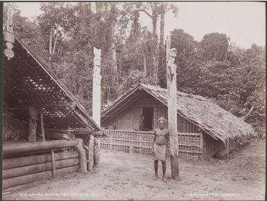 Man standing beside old gamal posts at Eteete, Ugi, Solomon Islands, 1906 / J.W. Beattie