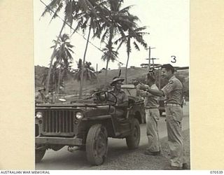 PORT MORESBY, PAPUA, 1944-02. AN AUSTRALIAN ARMY DRIVER, VERN UNTHANK (1), GIVING TRANSPORT TO TWO AMERICAN "HITCH HIKERS", STAFF SERGEANT J. DEVINE, OF CLAYTON, NEW JERSEY, (2) AND SERGEANT ALFRED ..