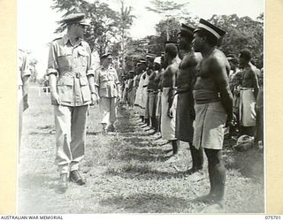 LAE, NEW GUINEA. 1944-09-09. VX13 LIEUTENANT-GENERAL S.G. SAVIGE, CB, CBE, DSO, MC, ED, GOC, NEW GUINEA FORCE INSPECTING NATIVES IN THE MALAHANG COMPOUND