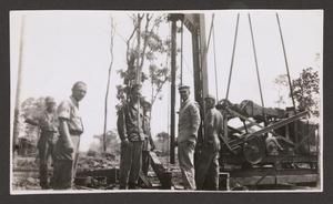 [Servicemen Drilling Well]