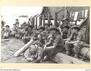 JACQUINOT BAY, NEW BRITAIN. 1945-09-09. PERSONNEL OF FIELD SERVICE SECTION, ATTACHED HEADQUARTERS 11 DIVISION WAITING TO EMBARK ON HMAS MANOORA. THE MANOORA CARRIED TROOPS FOR THE OCCUPATION OF THE ..