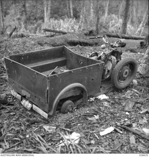 MILNE BAY, PAPUA. 1942-09. A JAPANESE TRICYCLE CONVEYANCE LANDED FROM ONE OF THE INVASION BARGES AND WRECKED IN THE BOMBING OF THE LANDING DUMPS BY THE RAAF