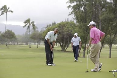 Barack Obama plays golf with Prime Minister Najib Razak, Joe Paulsen, and Mike Brush in Kaneohe Bay, Hawaii, December 24, 2014