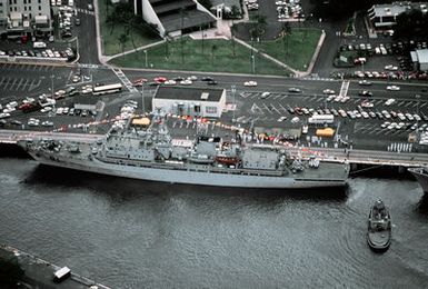 A port beam view of the Chinese training vessel ZHENG HE docked at a pier. The ship belongs to the Peoples Liberation Army/Navy, is transporting Chinese military personnel to Pearl Harbor for a visit