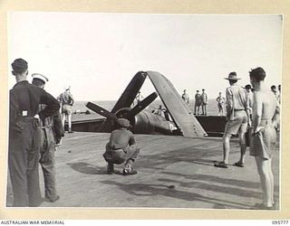 AT SEA OFF RABAUL, NEW BRITAIN. 1945-09-06. A CORSAIR AIRCRAFT BEING RAISED TO THE FLIGHT DECK OF THE AIRCRAFT CARRIER HMS GLORY. THE CORSAIRS WILL CIRCLE OVERHEAD DURING THE SURRENDER CEREMONY ..