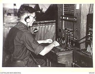 CAPE WOM, WEWAK AREA, NEW GUINEA, 1945-08-14. THE DIVISIONAL SWITCHBOARD IN OPERATION AT 6 DIVISION SIGNALS. IT IS THE KEY CENTRE OF TELEPHONIC COMMUNICATION BETWEEN THE DIVISION, BRIGADES AND ..