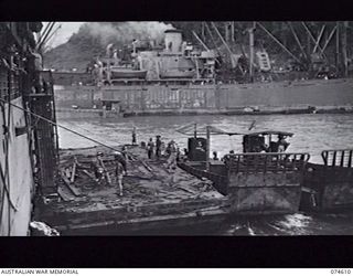 LAE AREA, NEW GUINEA. 6 JULY 1944. AUSTRALIAN TROOPS DISEMBARKING FROM HIS MAJESTY'S TRANSPORT "ORMISTON" INTO LANDING CRAFT IN THE HARBOUR