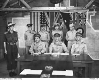 THE SOLOMON ISLANDS, 1945-09-08. THE ALLIED PARTY AWAITING TO CONDUCT THE SURRENDER CEREMONY AT II AUSTRALIAN CORPS HEADQUARTERS AT TOROKINA, BOUGAINVILLE ISLAND. IDENTIFIED PERSONNEL ARE, SEATED ..