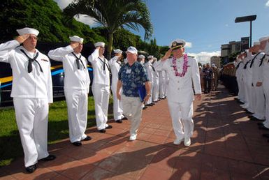 U.S. Navy USS ARIZONA survivor, retired LT. CMDR. Joseph Langdell (center left) returns a salute as he makes his way through an honor cordon for USS ARIZONA survivors. One hundred Sailors and Marines assigned to the Arleigh-Burke class guided-missile destroyers USS PAUL HAMILTON (DDG 60) and USS RUSSELL (DDG 59) and part of Combat Service Support Group 3, made up the honor cordon, which rendered honors to the survivors as they entered the USS ARIZONA Memorial Visitors Center at Pearl Harbor, Hawaii, on Dec. 5, 2006. (U.S. Navy PHOTO by Mass Communication SPECIALIST 1ST Class James E. Foehl) (Released)