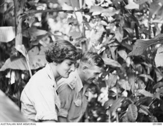 LAE, NEW GUINEA, 1945-05-18. LIEUTENANT G.A. BATES, AMENITIES OFFICER, AUSTRALIAN ARMY AMENITIES SERVICE, HEADQUARTERS LAE BASE (2), SHOWING SIGNALWOMAN B. GILES, AUSTRALIAN WOMEN'S ARMY SERVICE ..