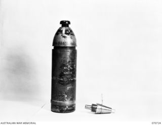 PORT MORESBY, PAPUA, NEW GUINEA, 1944-03-04. THE DISMANTLED VIEW OF A CAPTURED JAPANESE 75MM SHELL WITH FUSE. THE FINDING OF THIS HOLLOW CHARGE PROJECTILE SHOWED A RADICAL CHANGE IN JAPANESE ..