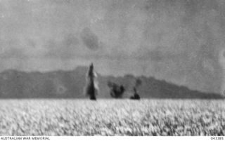OFF TULAGI, 1942-08-07. DURING THE LANDING ON TULAGI, JAPANESE AIRCRAFT ATTACKED THE UNITED STATES DESTROYER USS MUGFORD HITTING IT WITH A BOMB. PHOTOGRAPH SHOWS THE BEGINNING OF THE ATTACK. (SEE ..