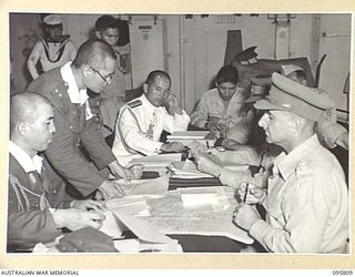 AT SEA OFF RABAUL, NEW BRITAIN. 1945-09-06. AUSTRALIAN AND JAPANESE STAFF OFFICERS IN CONFERENCE AFTER THE SURRENDER CEREMONY ABOARD THE AIRCRAFT CARRIER HMS GLORY. THE SURRENDER OF ALL JAPANESE ..