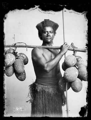 Fijian man carrying breadfruit