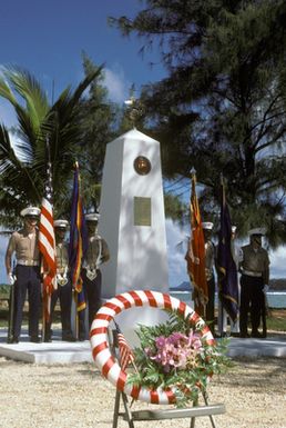 A joint Marine Corps/Navy color guard stands at attention at the Congressional Medal of Honor Monument during a dedication and wreath laying ceremony. The monument honors four Marines for heroism above and beyond the call of duty while fighting the Japanese during World War II