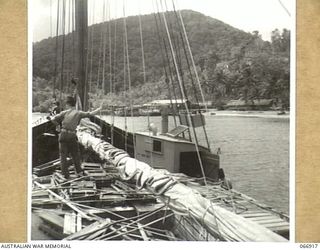 MILNE BAY, NEW GUINEA, AUSTRALIA. 1944-06-14/02. A VESSEL OF THE 12TH SMALL SHIPS COMPANY, APPROACHING KWIARI IN THE CHINA STRAIT