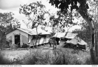 KOITAKI, NEW GUINEA. 1943-07-13. EXTERIOR VIEW OF THE FACILITIES AND LIVING QUARTERS OF THE AUSTRALIAN ARMY EDUCATION SERVICE CENTRE AT SEVENTEEN MILE. LEFT TO RIGHT: NX144078 SERGEANT (SGT) L. R. ..