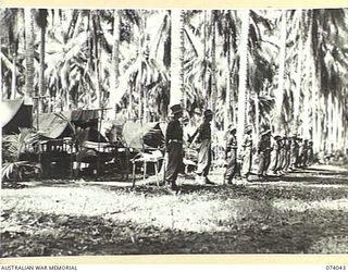 SIAR, NEW GUINEA. 1944-06-20. TROOPS OF NO.9 PLATOON, A COMPANY, 58/59TH INFANTRY BATTALION STANDING BY THEIR TENTS FOR THE COMMANDING OFFICER'S INSPECTION