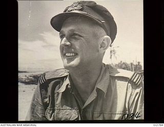 MOMOTE, LOS NEGROS ISLAND, ADMIRALTY ISLANDS. C. 1944-04. INFORMAL PORTRAIT OF A TYPICAL PILOT OF NO. 76 (KITTYHAWK) SQUADRON RAAF, FLIGHT LIEUTENANT LEIGH BOWES OF SYDNEY, NSW, A FORMER BANK ..