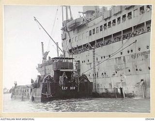 TOROKINA, BOUGAINVILLE. 1945-07-26. THE FIRST CONTINGENT OF "FIVE YEAR RELEASE PERSONNEL" TO LEAVE FOR THE RETURN TO AUSTRALIA. THE MEN, WHO HAVE COMPLETED FIVE YEARS IN THE ARMY, ARE BOARDING THE ..