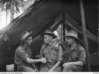 MADANG, NEW GUINEA. 1944-08-23. AUSTRALIAN ARMY PERSONNEL ENJOY A GOOD YARN BEFORE LEAVING THEIR UNIT FOR THEIR HOME STATES AND LEAVE. THEY ARE:- NX58247 SERGEANT A. L. FRASER, MILITARY HISTORY ..