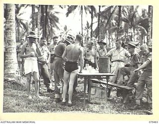 JACQUINOT BAY, NEW BRITAIN. 1945-03-11. REFRESHMENTS ARE BEING SERVED AT THE YOUNG MEN'S CHRISTIAN ASSOCIATION STALL DURING THE AQUATIC CARNIVAL OF THE NEW BRITAIN YACHT CLUB, 5TH BASE SUB AREA. ..