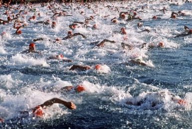 Participants compete in the 2.4-mile swimming event, part of the 1987 Ironman Competition