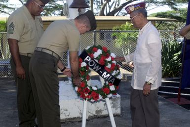 CHIEF Of STAFF, Colonel J. A. Gillis III, (center), Marine Forces Pacific, Camp H. M. Smith, Hawaii, and Guest Speaker Major Fredric Foz, USA, (right), (Ret.) lay a wreath to honor the POW/MIAs during the ceremony