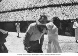 Unidentified man receiving a necklace from a native woman, Marshall Islands, 1947