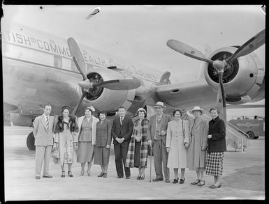 Group of people standing beside the British Commonwealth Pacific Airlines aircraft RMA Endeavour at Whenuapai before White's Fijian tour