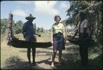 Frances Harwood with two men and miniature canoes